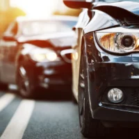 closeup-of-two-cars-with-damaged-front-ends-after-a-collision