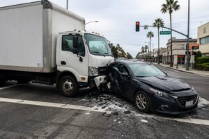 Delivery truck accident in Costa Mesa California involving a commercial vehicle and passenger car at a busy intersection