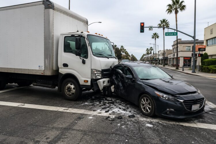 Delivery truck accident in Costa Mesa California involving a commercial vehicle and passenger car at a busy intersection